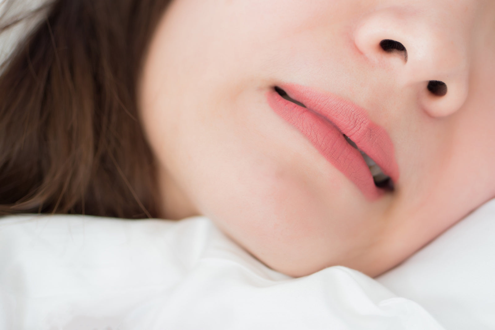 woman sleeping while grinding teeth